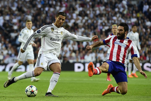 Cristiano Ronaldo shoots with Arda Turan sliding in an attempt to block it