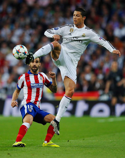 Cristiano Ronaldo jumps high in the air to control the ball with his right boot