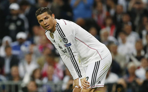 Cristiano Ronaldo leans forward and holds on to his thighs