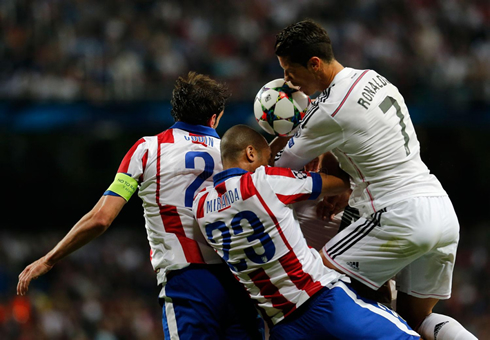 Cristiano Ronaldo heading the ball with Godin and Mirana opposition in the air
