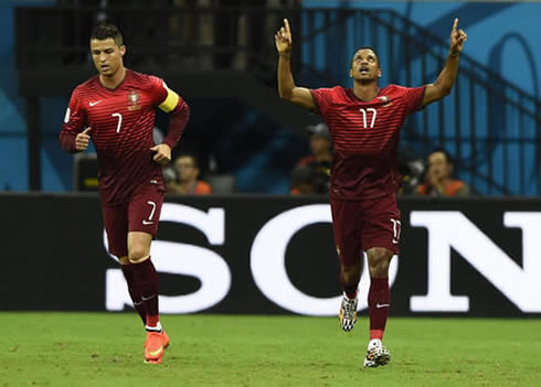 Nani raising his two hands to the air, as he celebrates Portugal's opener against the USA, next to Cristiano Ronaldo