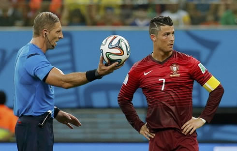 Cristiano Ronaldo looking away as the referee hands him the ball in Portugal vs USA, at the FIFA World Cup 2014