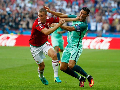 Cristiano Ronaldo being pulled by his opponent, in Hungary vs Portugal in the EURO 2016