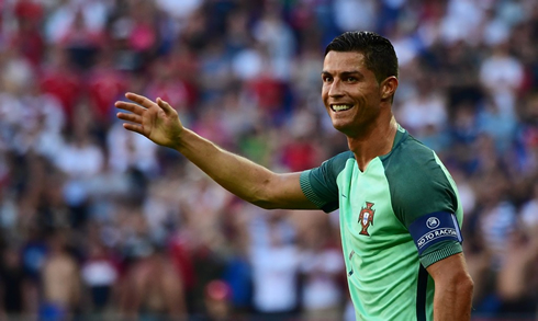 Cristiano Ronaldo smiling and raising his right arm during Portugal vs Hungary for the European Championship in 2016