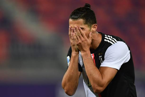Cristiano Ronaldo covering his face with his hands