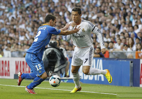 Cristiano Ronaldo being held by his chest by an opponent, in Real Madrid vs Getafe