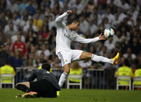 Cristiano Ronaldo stretching the most he can to reach the ball, but almost doing an handball