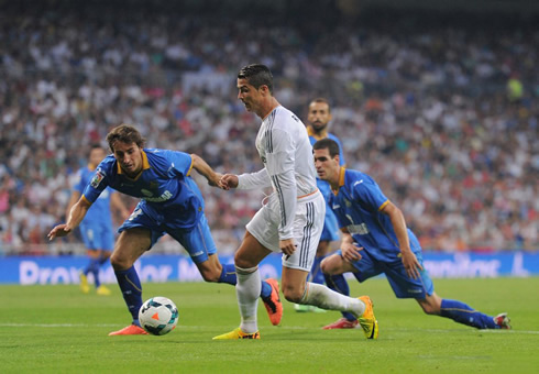 Cristiano Ronaldo leaving two defenders on the ground after a fast dribble