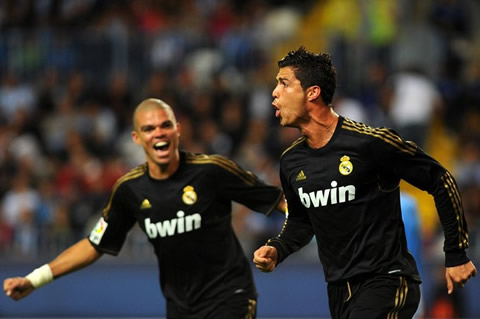 Cristiano Ronaldo celebrates a goal against Malaga, with Pepe running behind him