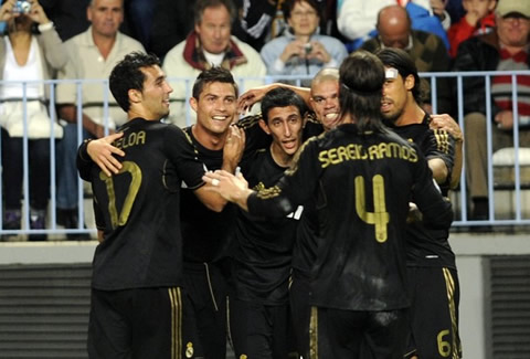 Cristiano Ronaldo in a group hug, with Real Madrid players