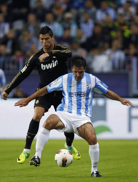 Cristiano Ronaldo trying to steal the ball from a Malaga's defender