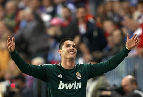 Cristiano Ronaldo raising his arms and releasing his ironic smile, in Real Madrid 2012-2013