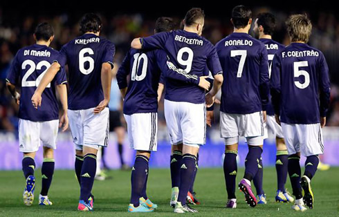 Real Madrid team players marching back to their half, after celebrating the opener in their game against Valencia, in 2013