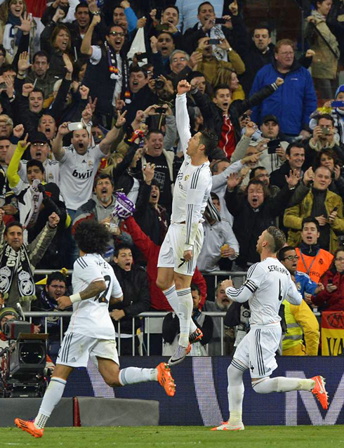 Cristiano Ronaldo jumping high with his fist raised, after scoring in Real Madrid 3-4 Barcelona