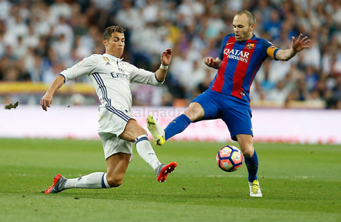 Cristiano Ronaldo and Iniesta fighting for a loose ball in El Clasico 2017
