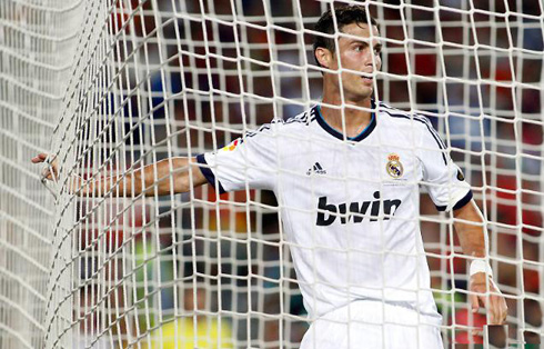 Cristiano Ronaldo touching Barcelona's goal net with his right hand, in the Clasico 2012-2013