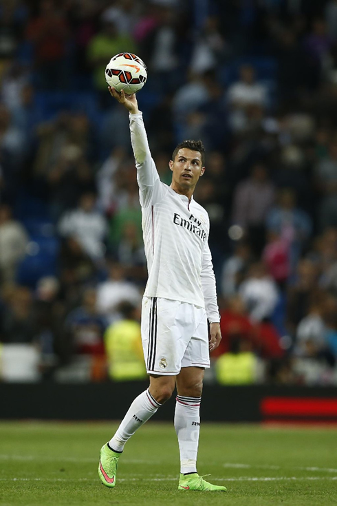 Cristiano Ronaldo holding the ball of the game high in the air, after scoring a 4-goal poker in Real Madrid 5-1 Elche, in La Liga 2014-2015