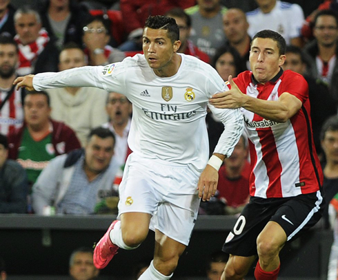 Cristiano Ronaldo runs away from De Marcos, as he's being hold by his arm