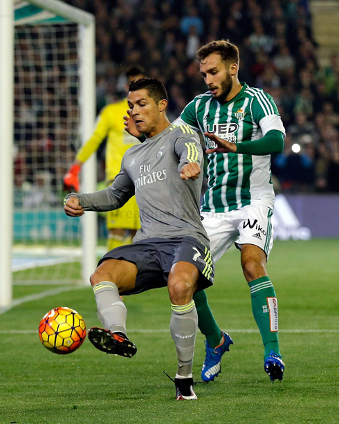 Cristiano Ronaldo tries to turn with a defender pushing him on the back