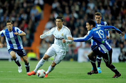 Cristiano Ronaldo running away from a Real Sociedad defender, in a Real Madrid game for La Liga in 2012