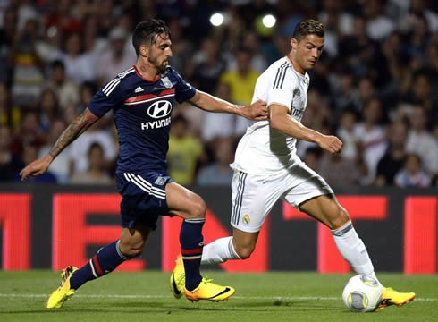 Cristiano Ronaldo holding to on to a push by Miguel Lopes, in Olympique Lyon vs Real Madrid, in 2013-2014