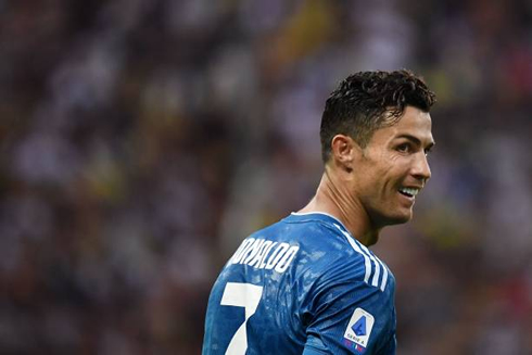 Cristiano Ronaldo looking above his should with a smile on his face