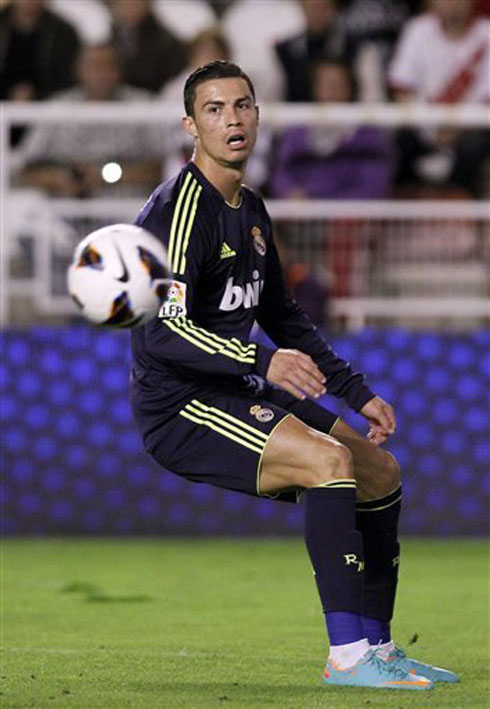 Cristiano Ronaldo bending backwards as he watches the ball going into an unwanted direction, in Real Madrid 2012-2013