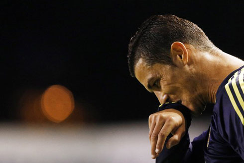 Cristiano Ronaldo cleaning his mouth with the tip of his shirt slieve, in a Real Madrid match at 2012-2013