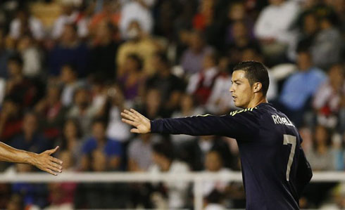 Cristiano Ronaldo touching hands with a Real Madrid teammate, after scoring against Rayo Vallecano in 2012