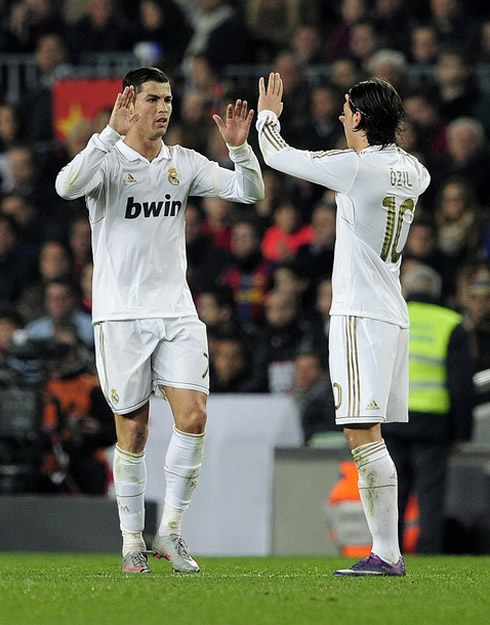 Cristiano Ronaldo touching hands with Mesut Ozil, as Real Madrid prepares to play against Barcelona in the Camp Nou, in 2012