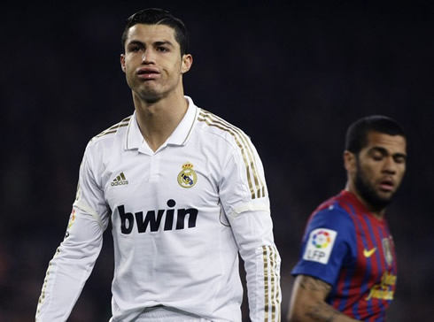 Cristiano Ronaldo frustration look, with Daniel Alves behind him, in Barcelona vs Real Madrid in 2011-2012