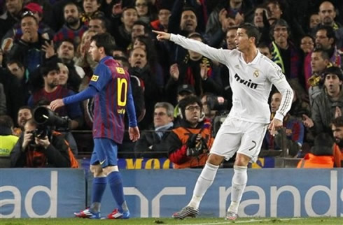 Cristiano Ronaldo pointing to someone, with Lionel Messi standing a few meters from him, in Barcelona vs Real Madrid 2012