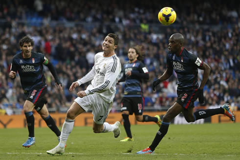 Cristiano Ronaldo chasing a ball that is getting away from him, in Real Madrid 2014