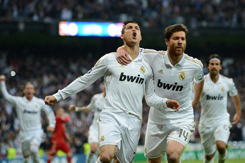 Cristiano Ronaldo and Xabi Alonso running together to celebrate Real Madrid goal against Bayern Munich, in 2012