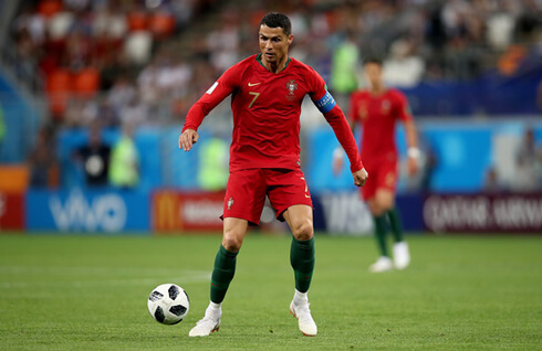 Cristiano Ronaldo between two Iran defenders in the 2018 FIFA World Cup