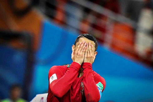Cristiano Ronaldo covers his face with his hands after missing a penalty in the World Cup in 2018