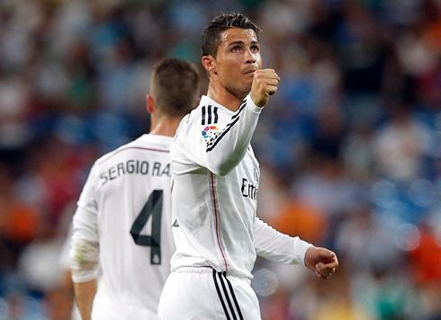 Cristiano Ronaldo raises his right hand closed, after scoring Real Madrid's second goal against Cordoba