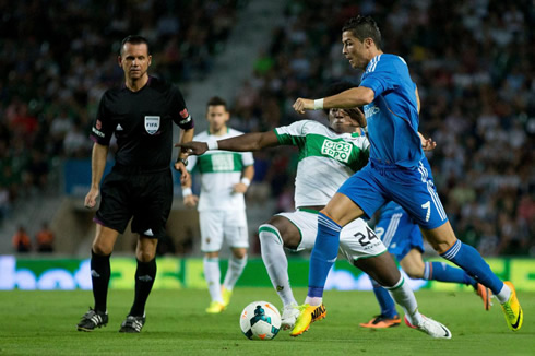 Cristiano Ronaldo leaves a defender behind as he avoids his sliding tackle, in La Liga