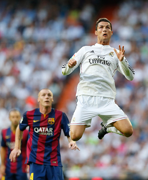 Cristiano Ronaldo rising in the air during a Real Madrid vs Barcelona Clasico in 2014