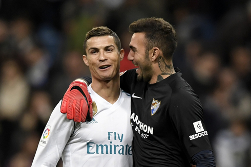 Cristiano Ronaldo smiling next to Roberto, Malaga goalkeeper