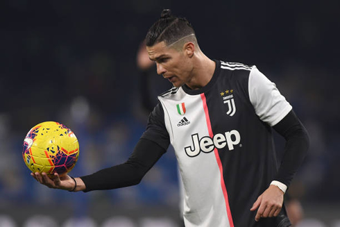 Cristiano Ronaldo handing the ball to someone