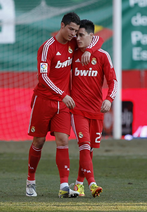 Cristiano Ronaldo with his arm around Callejón, after a Real Madrid goal in 2012