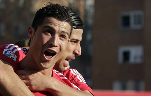 Cristiano Ronaldo making a surprised look and face, while Sami Khedira holds him from behind, in Real Madrid 2012