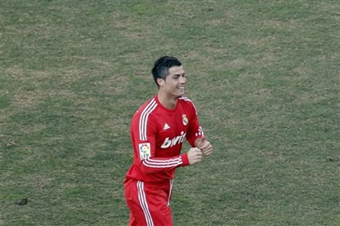Cristiano Ronaldo showing thumbs up in a Real Madrid red jersey in 2012