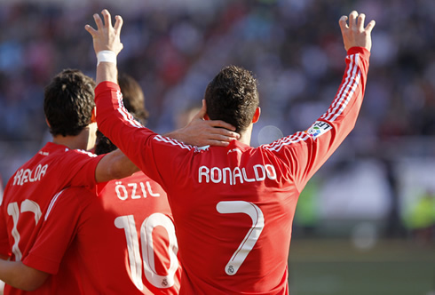 Cristiano Ronaldo celebrating with Arbeloa and Ozil, and doing the claw gesture to the crowd