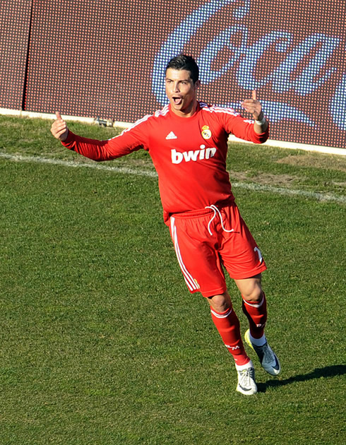 Cristiano Ronaldo in red, running backwards and celebrating Real Madrid goal in 2012
