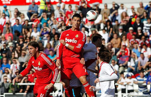 Cristiano Ronaldo jumping and heading the ball in a corner kick
