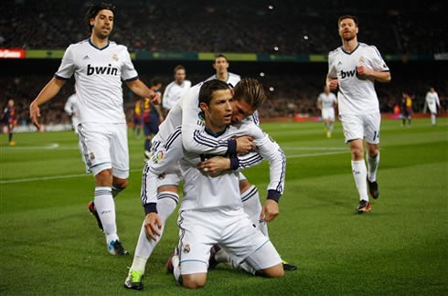 Cristiano Ronaldo on his knees at the Camp Nou, with his Real Madrid teammates joining him to celebrate the Merengues goal