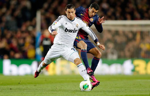 Cristiano Ronaldo being pushed by Pedrito, during a play at the Barcelona vs Real Madrid game for the Copa del Rey 2013