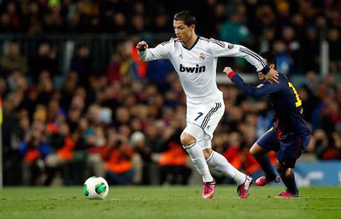 Cristiano Ronaldo taking off and leaving behind a Barcelona opponent, in the Clasico for the Copa del Rey in 2013